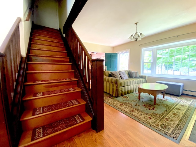 29 Grumman Ave, Wilton, CT 06897 - stairway featuring wood finished floors, a chandelier, and a baseboard heating unit