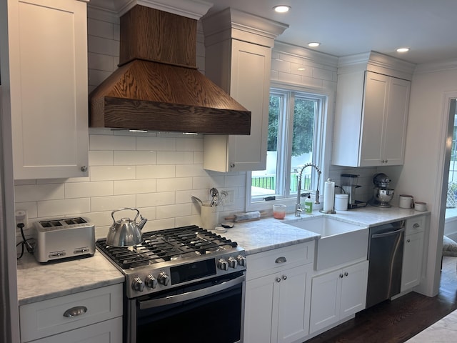 8 Sharon Ln, Old Saybrook, CT 06475 - kitchen with stainless steel appliances, premium range hood, backsplash, white cabinets, and light stone counters