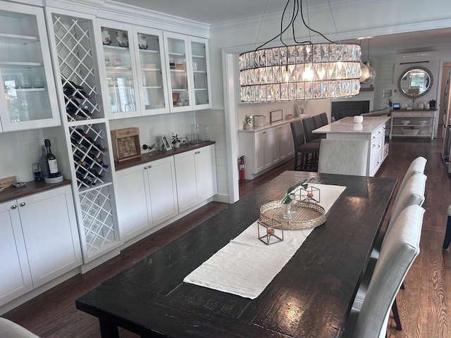 8 Sharon Ln, Old Saybrook, CT 06475 - dining room with dark wood-style flooring, a bar, and crown molding
