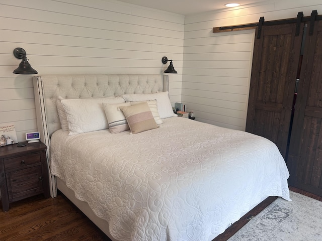 8 Sharon Ln, Old Saybrook, CT 06475 - bedroom with a barn door, wood walls, and wood finished floors