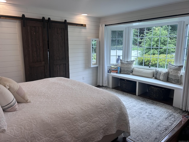 8 Sharon Ln, Old Saybrook, CT 06475 - bedroom with a barn door and wooden walls