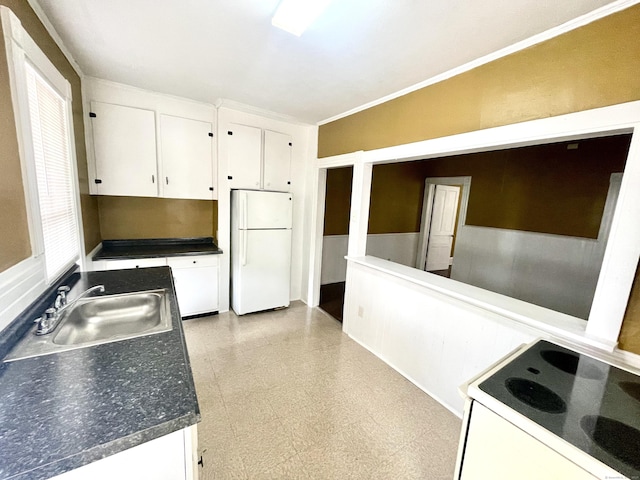 271 S Main St, Torrington, CT 06790 - kitchen featuring white appliances, white cabinetry, light flooring, ornamental molding, and dark countertops