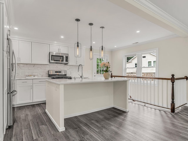 39 Beaver Brook Rd, Danbury, CT 06810 - kitchen featuring dark wood-type flooring, light countertops, stainless steel appliances, backsplash, and an island with sink