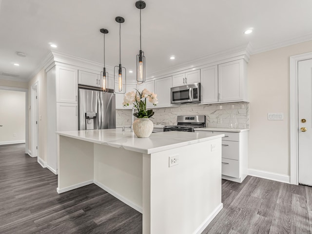 39 Beaver Brook Rd, Danbury, CT 06810 - kitchen featuring appliances with stainless steel finishes, crown molding, dark wood-type flooring, tasteful backsplash, and an island with sink