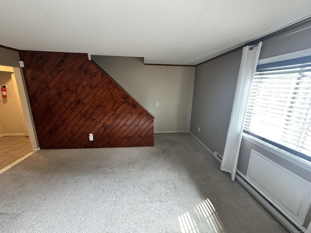 519 Scott Rd, Waterbury, CT 06705 - unfurnished living room with carpet floors, a baseboard radiator, and a textured ceiling