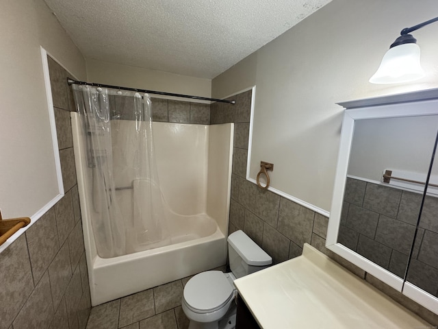 519 Scott Rd, Waterbury, CT 06705 - bathroom with tile walls, a textured ceiling, shower / tub combo with curtain, vanity, and wainscoting