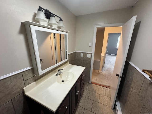 519 Scott Rd, Waterbury, CT 06705 - bathroom featuring tile walls, vanity, tile patterned floors, and wainscoting