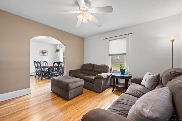 20 Harris St, Enfield, CT 06082 - living area with arched walkways, light wood-style flooring, and a ceiling fan