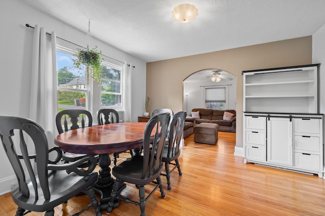 20 Harris St, Enfield, CT 06082 - dining room with light wood-style floors, arched walkways, a textured ceiling, and a ceiling fan
