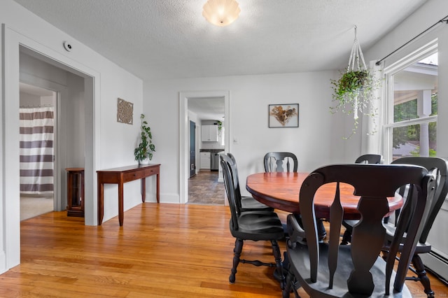 20 Harris St, Enfield, CT 06082 - dining area with light wood-style flooring and a textured ceiling