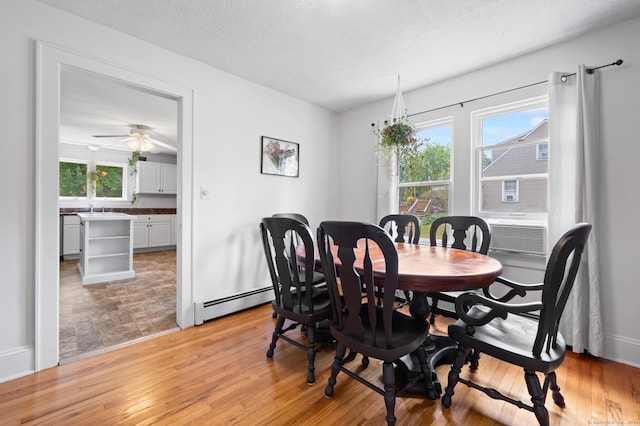 20 Harris St, Enfield, CT 06082 - dining room with baseboard heating, healthy amount of natural light, light wood-type flooring, and a ceiling fan