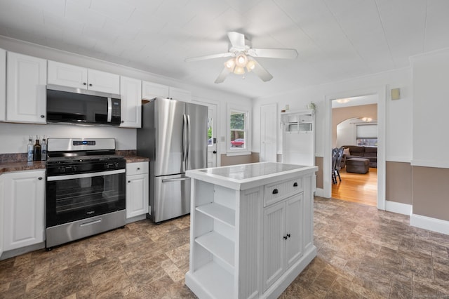 20 Harris St, Enfield, CT 06082 - kitchen featuring stainless steel appliances, open shelves, arched walkways, white cabinets, and a ceiling fan