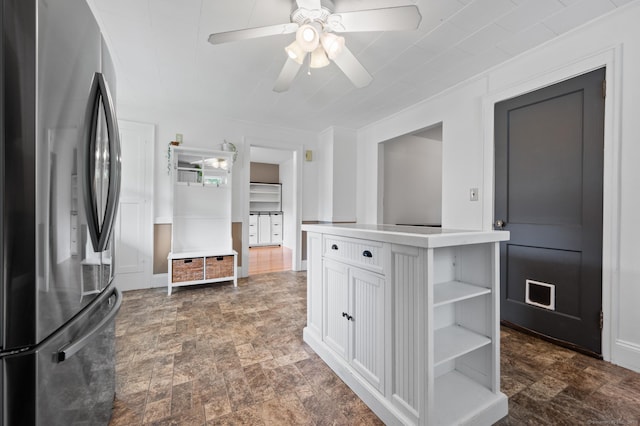20 Harris St, Enfield, CT 06082 - kitchen with freestanding refrigerator, open shelves, white cabinetry, and stone finish flooring
