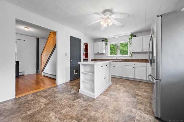 20 Harris St, Enfield, CT 06082 - kitchen featuring freestanding refrigerator, white cabinets, a ceiling fan, open shelves, and baseboard heating