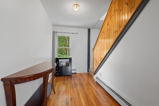 20 Harris St, Enfield, CT 06082 - hall featuring stairs, a baseboard radiator, baseboard heating, and light wood-style flooring
