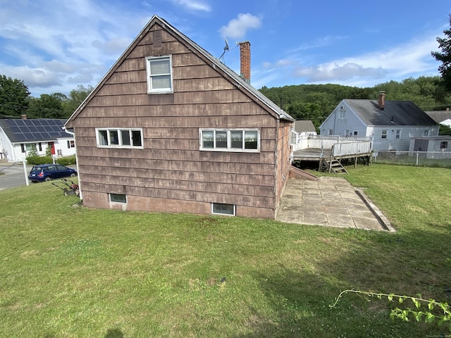 115 Cooper Dr, Waterbury, CT 06704 - view of side of property featuring a chimney, a patio, a lawn, and crawl space