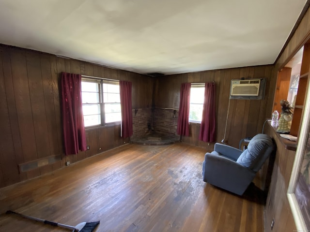 115 Cooper Dr, Waterbury, CT 06704 - sitting room with wood finished floors, wooden walls, and a wall mounted air conditioner