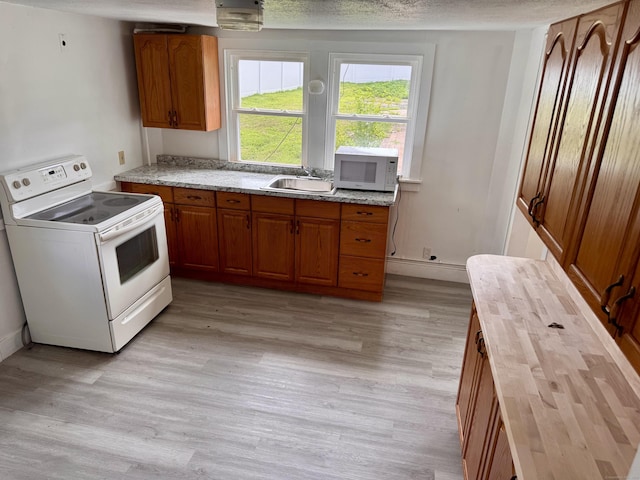 1 Ferry Ln, Portland, CT 06480 - kitchen with white appliances, brown cabinets, wood counters, light wood-style floors, and a textured ceiling