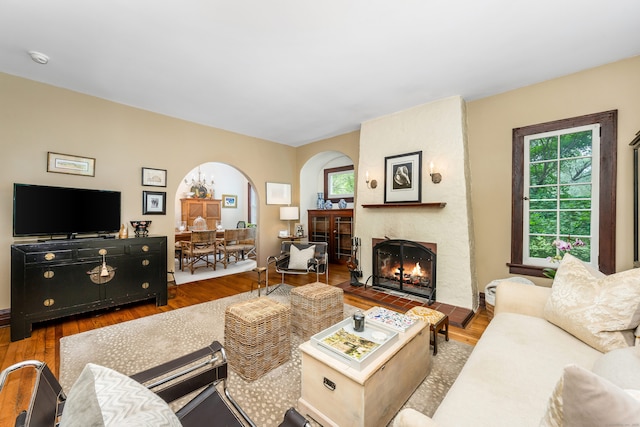 48 Own Home Ave, Wilton, CT 06897 - living area featuring a fireplace, arched walkways, and wood finished floors