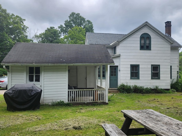 130 Westchester Rd, Colchester, CT 06415 - back of house with a chimney, a yard, roof with shingles, and covered porch