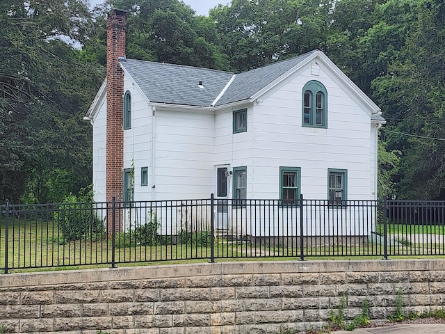 130 Westchester Rd, Colchester, CT 06415 - view of side of property with a chimney, a shingled roof, a lawn, and a wooded view