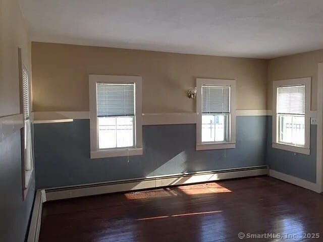 130 Westchester Rd, Colchester, CT 06415 - unfurnished room featuring baseboard heating, plenty of natural light, and wood finished floors