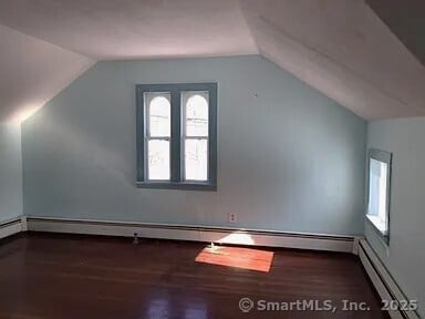 130 Westchester Rd, Colchester, CT 06415 - bonus room featuring a baseboard radiator, vaulted ceiling, wood finished floors, and plenty of natural light