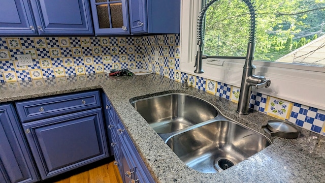 32 Rocky Glen Rd, Danbury, CT 06810 - kitchen featuring blue cabinetry, tasteful backsplash, glass insert cabinets, and dark stone counters