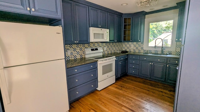 32 Rocky Glen Rd, Danbury, CT 06810 - kitchen with white appliances, wood finished floors, dark countertops, decorative backsplash, and glass insert cabinets