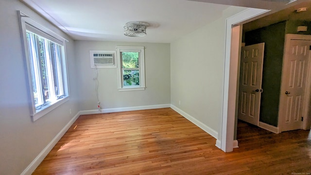 32 Rocky Glen Rd, Danbury, CT 06810 - empty room featuring healthy amount of natural light, light wood-type flooring, and an AC wall unit