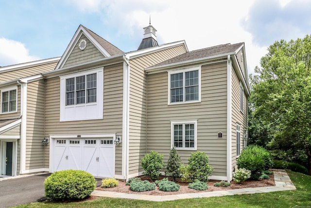 21 Great Heron Ln Unit 21, Brookfield, CT 06804 - view of front of property with an attached garage, a chimney, and asphalt driveway
