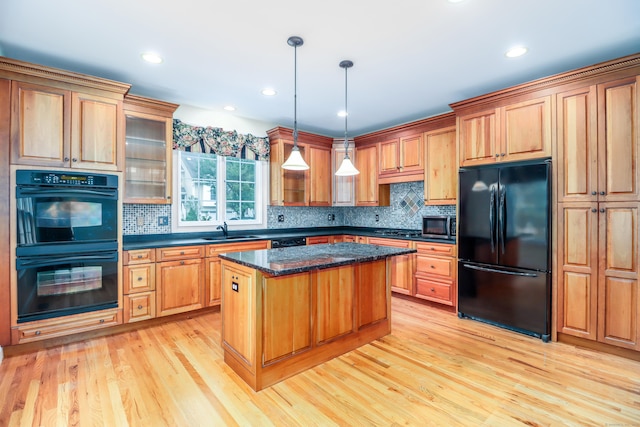 21 Great Heron Ln Unit 21, Brookfield, CT 06804 - kitchen with black appliances, light wood-style floors, backsplash, a kitchen island, and recessed lighting