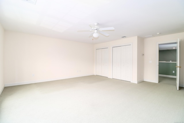 21 Great Heron Ln Unit 21, Brookfield, CT 06804 - unfurnished bedroom featuring two closets, light carpet, and ceiling fan