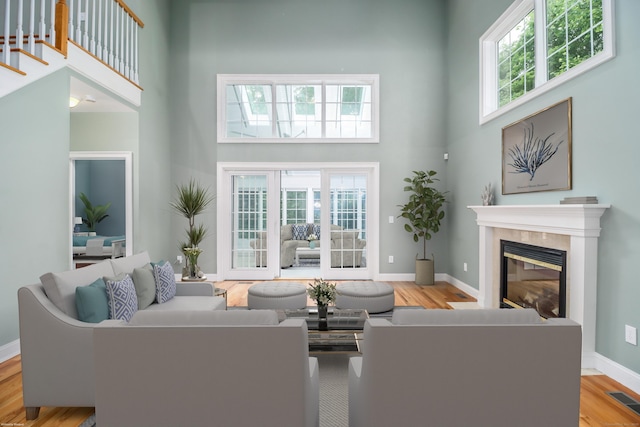 21 Great Heron Ln Unit 21, Brookfield, CT 06804 - living area with a high ceiling, a glass covered fireplace, and wood finished floors