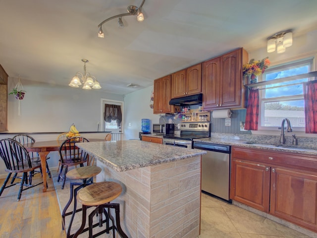 15 Courtney Ln, Killingly, CT 06241 - kitchen with stainless steel appliances, light stone countertops, a chandelier, and a center island