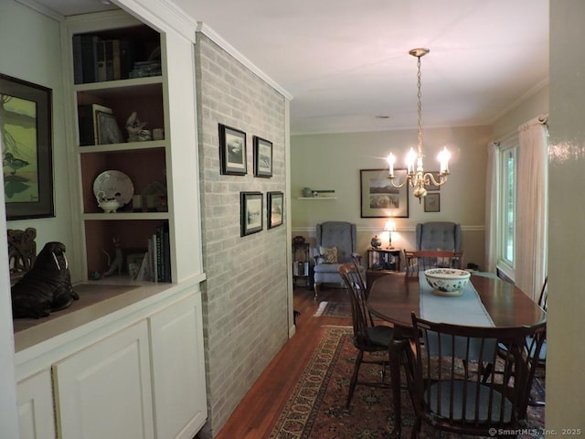 29 Graham Rd, East Windsor, CT 06016 - dining space featuring built in shelves, dark wood-style flooring, a chandelier, and ornamental molding