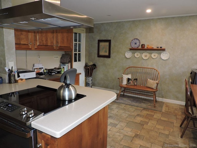 29 Graham Rd, East Windsor, CT 06016 - kitchen with island exhaust hood, a desk, stone tile flooring, brown cabinetry, and crown molding