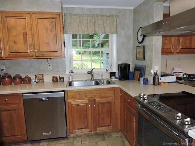 29 Graham Rd, East Windsor, CT 06016 - kitchen featuring stainless steel appliances, wall chimney range hood, light countertops, brown cabinetry, and stone finish floors