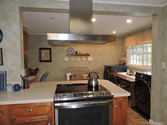 29 Graham Rd, East Windsor, CT 06016 - kitchen with stainless steel electric range oven, wall chimney range hood, washer / dryer, light countertops, and brown cabinets