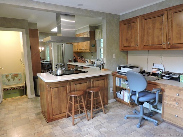 29 Graham Rd, East Windsor, CT 06016 - kitchen featuring island range hood, appliances with stainless steel finishes, light stone finish floors, and brown cabinetry