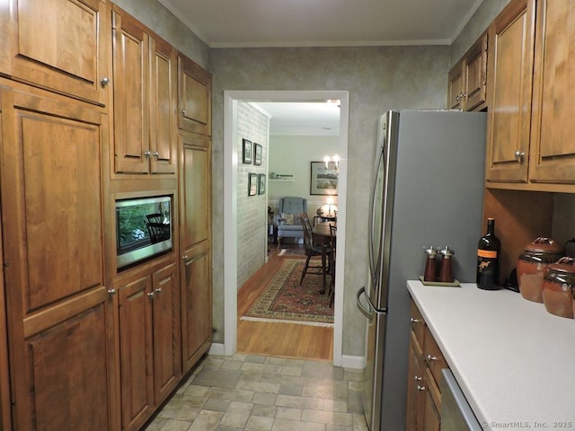29 Graham Rd, East Windsor, CT 06016 - kitchen featuring stainless steel appliances, light stone finish flooring, light countertops, brown cabinets, and ornamental molding