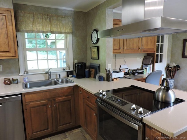 29 Graham Rd, East Windsor, CT 06016 - kitchen featuring wall chimney range hood, appliances with stainless steel finishes, light countertops, a desk, and brown cabinetry