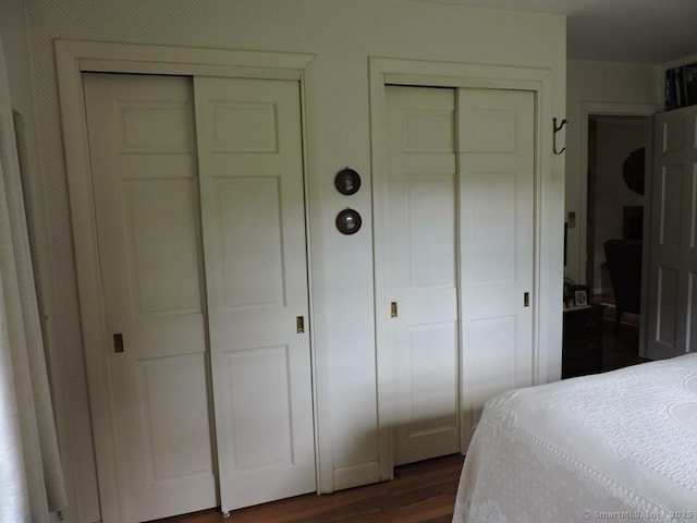 29 Graham Rd, East Windsor, CT 06016 - bedroom featuring multiple closets and dark wood-type flooring