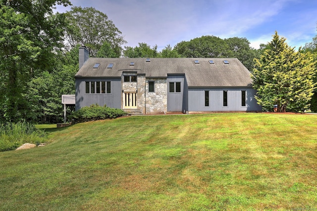 35 Millo Dr, Monroe, CT 06468 - back of house featuring a chimney, stone siding, a yard, and entry steps