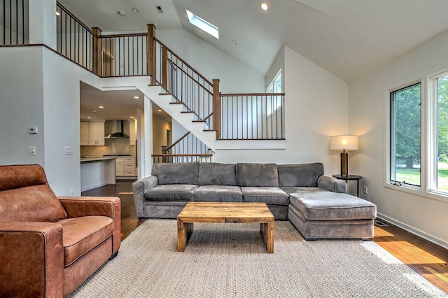 35 Millo Dr, Monroe, CT 06468 - living room featuring wood finished floors, a skylight, high vaulted ceiling, and stairs