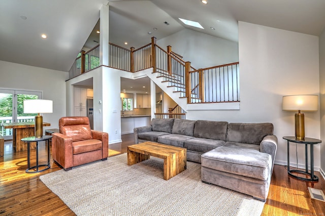 35 Millo Dr, Monroe, CT 06468 - living area with hardwood / wood-style flooring, a skylight, high vaulted ceiling, stairway, and recessed lighting