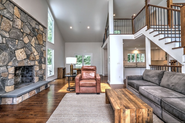 35 Millo Dr, Monroe, CT 06468 - living room with high vaulted ceiling, wood finished floors, stairway, a fireplace, and recessed lighting