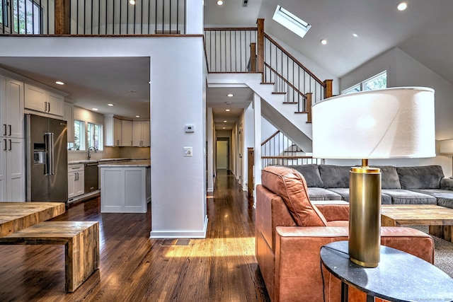 35 Millo Dr, Monroe, CT 06468 - living area with dark wood-type flooring, a towering ceiling, a skylight, stairs, and recessed lighting