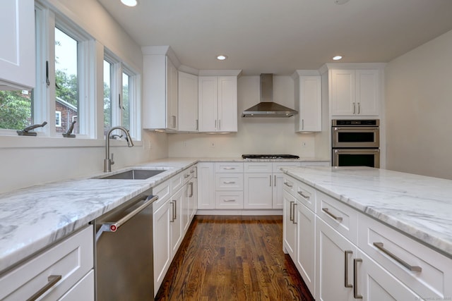35 Millo Dr, Monroe, CT 06468 - kitchen featuring recessed lighting, wall chimney range hood, appliances with stainless steel finishes, dark wood-style flooring, and white cabinets