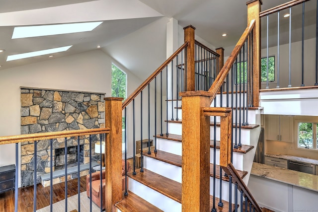 35 Millo Dr, Monroe, CT 06468 - staircase with wood finished floors, a skylight, vaulted ceiling, recessed lighting, and a fireplace